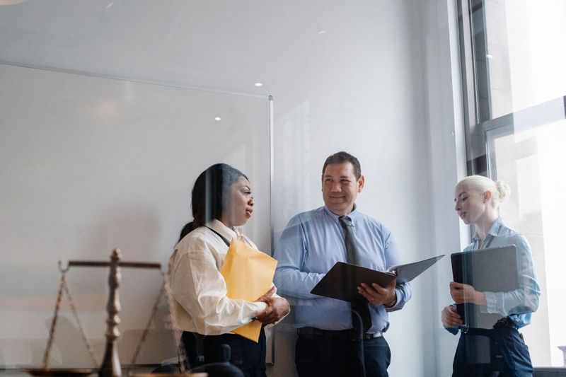 Legal professionals discussing work in an office