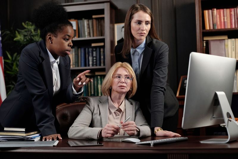 Legal professionals reviewing work on a computer